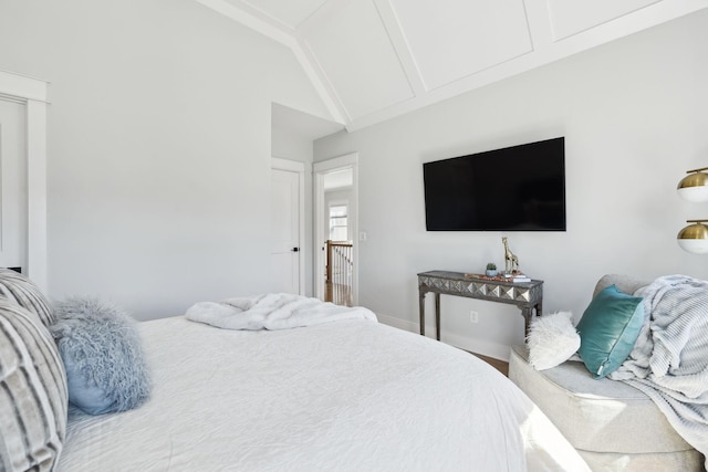 bedroom featuring vaulted ceiling and baseboards