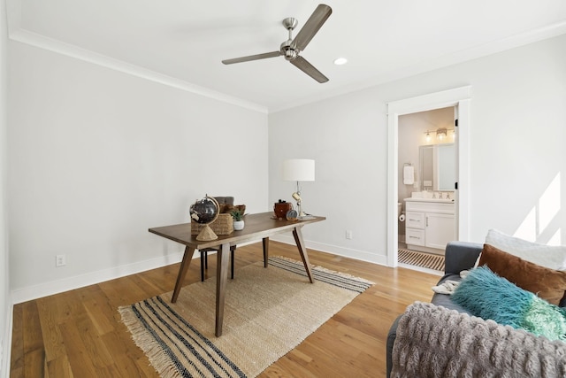 home office featuring light wood-style flooring, a ceiling fan, recessed lighting, crown molding, and baseboards