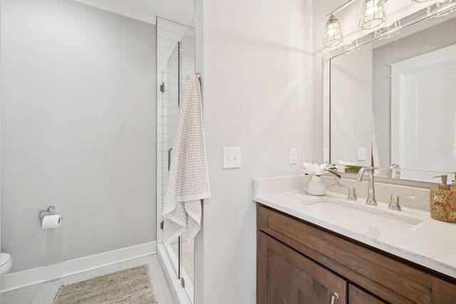 full bath featuring toilet, a shower stall, tile patterned flooring, baseboards, and vanity