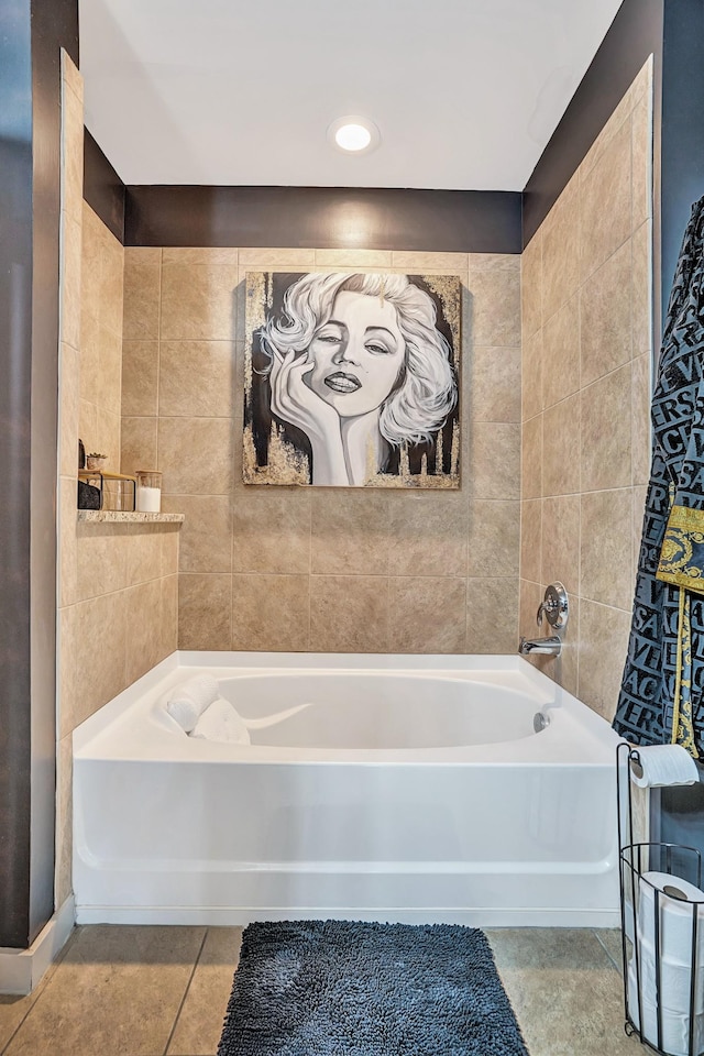 bathroom with tile patterned floors, a bath, and tile walls