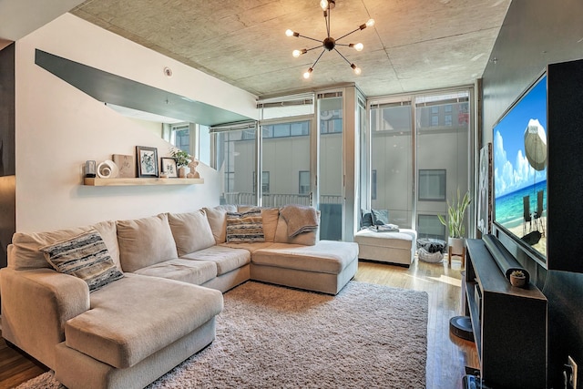 living area featuring a wall of windows, an inviting chandelier, and wood finished floors