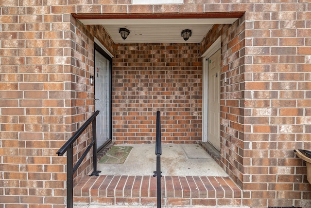 property entrance featuring brick siding