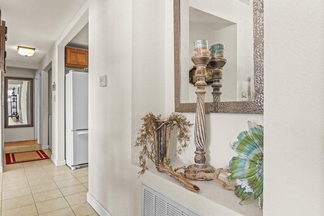 hall featuring light tile patterned floors