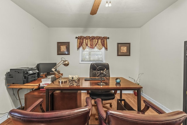 office featuring wood finished floors, baseboards, and ceiling fan