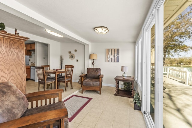 living room with light tile patterned floors and baseboards