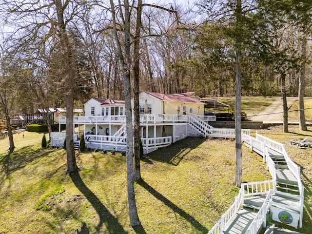 exterior space featuring a wooden deck, stairs, and a yard