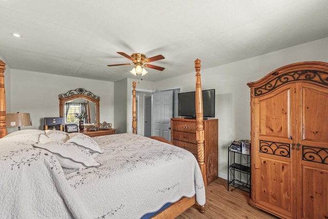 bedroom with a ceiling fan and light wood-style floors