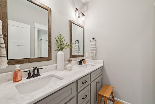 full bath with a sink and double vanity