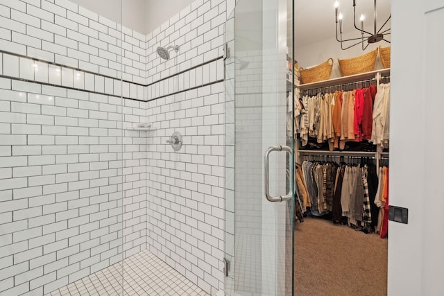 full bathroom featuring a spacious closet and a stall shower