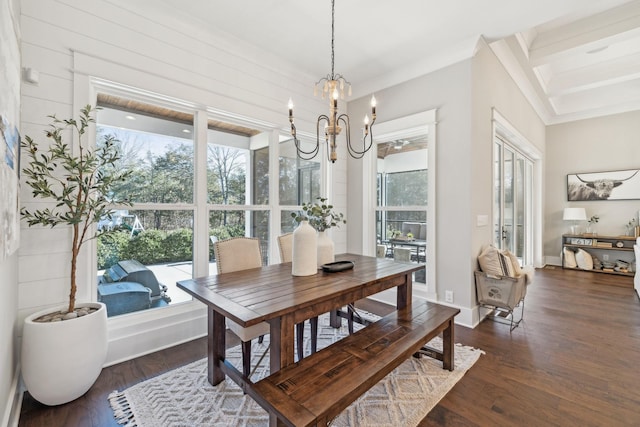 dining room with a notable chandelier, baseboards, dark wood-style flooring, and a wealth of natural light