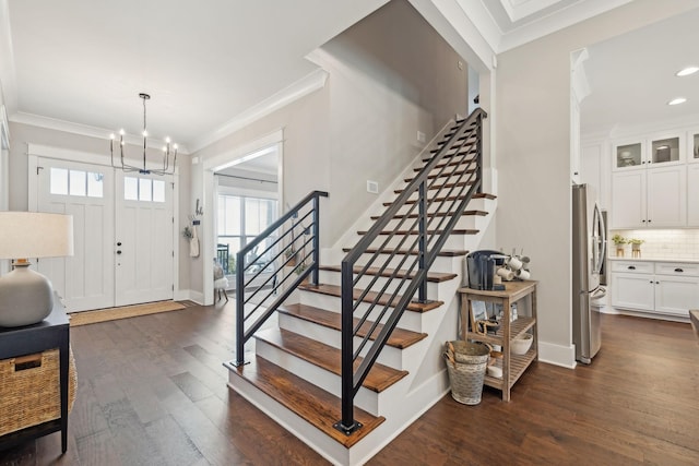 entryway with stairway, dark wood-type flooring, and crown molding