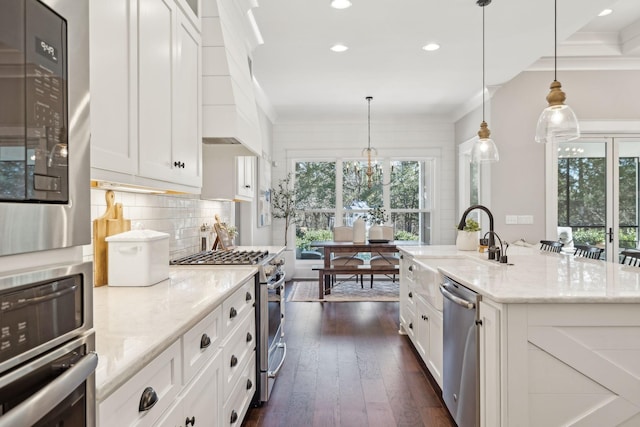 kitchen with tasteful backsplash, stainless steel appliances, dark wood-style floors, white cabinetry, and a sink