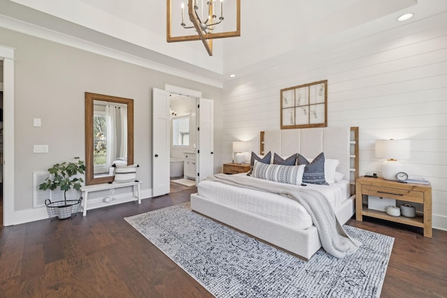 bedroom featuring wood finished floors, baseboards, an inviting chandelier, recessed lighting, and ensuite bathroom