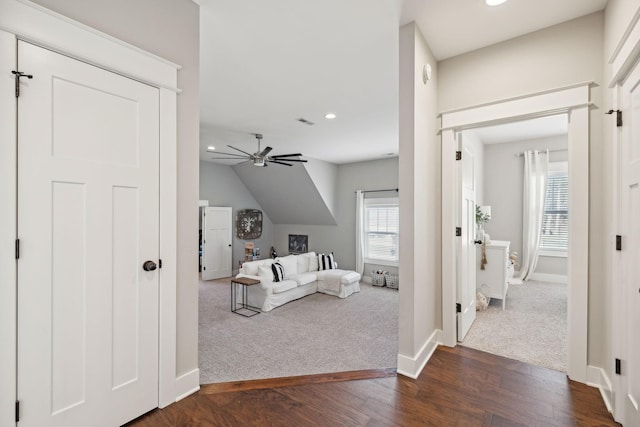 living area with dark wood finished floors, recessed lighting, baseboards, and dark colored carpet