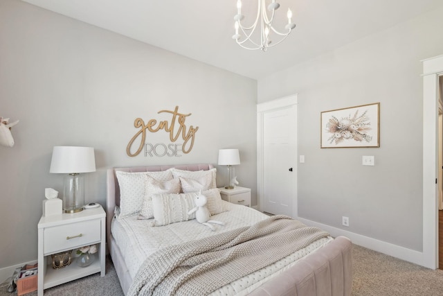 carpeted bedroom with baseboards and a chandelier