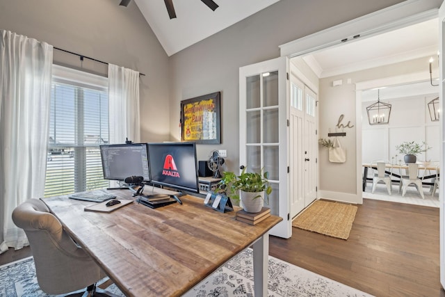 office with ceiling fan with notable chandelier, crown molding, wood finished floors, and a wealth of natural light