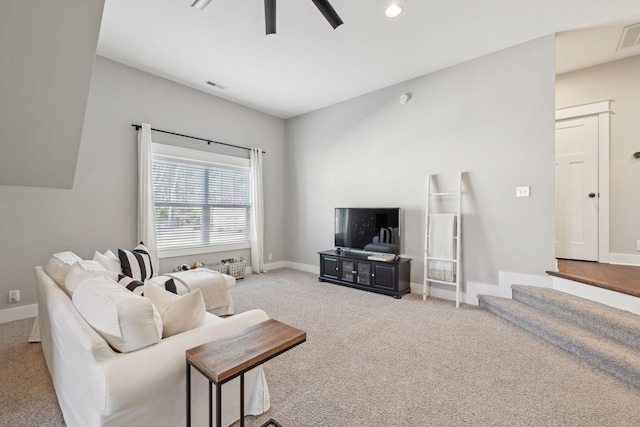 carpeted living room with baseboards, visible vents, and ceiling fan