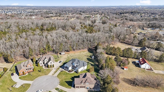 aerial view featuring a wooded view and a residential view