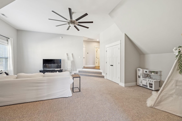 carpeted living area with a ceiling fan, lofted ceiling, visible vents, and baseboards