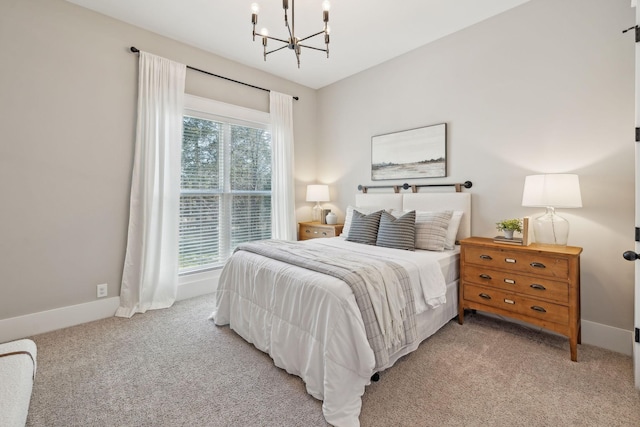 carpeted bedroom with an inviting chandelier and baseboards