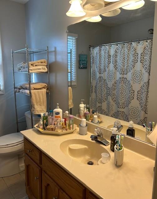 full bathroom with tile patterned flooring, toilet, vanity, and a shower with curtain