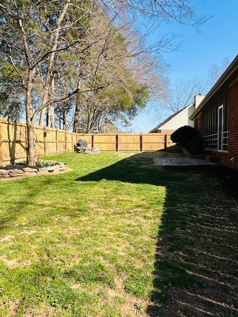 view of yard with a fenced backyard