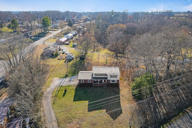 birds eye view of property with a forest view