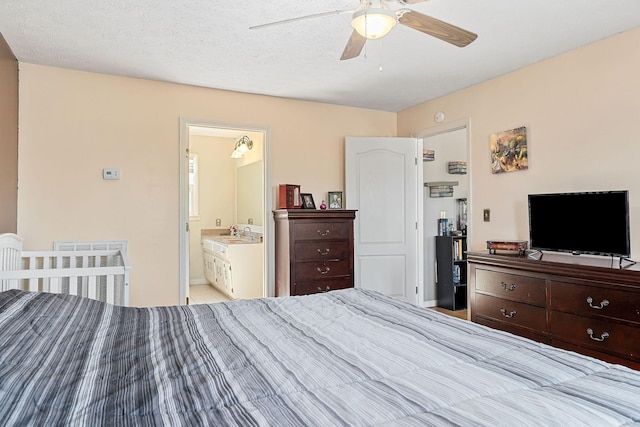 bedroom with a sink, a textured ceiling, radiator heating unit, connected bathroom, and ceiling fan