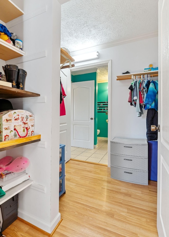 walk in closet featuring light wood finished floors