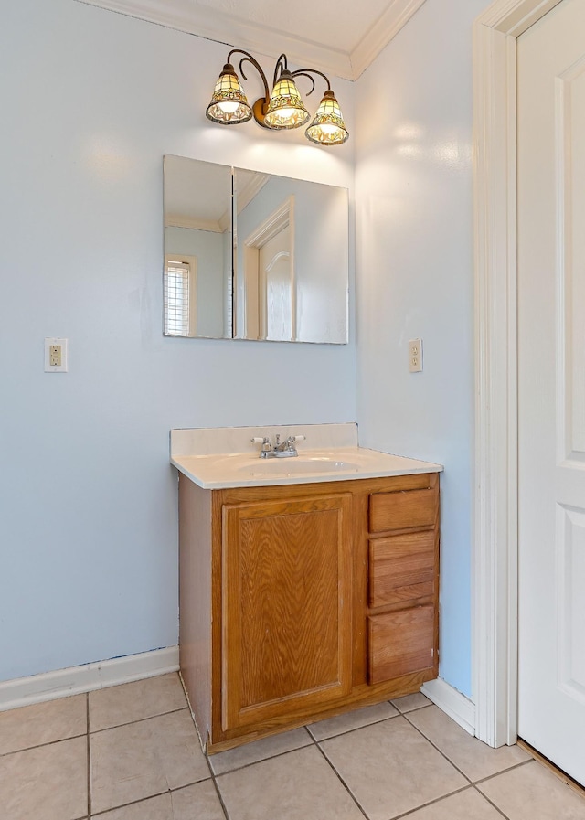 bathroom with tile patterned flooring, vanity, crown molding, and baseboards