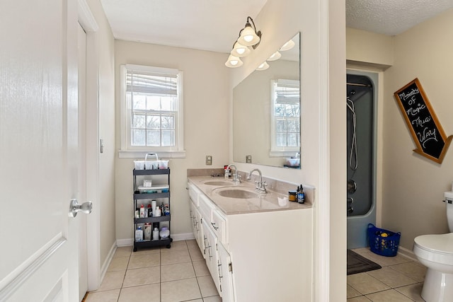 bathroom featuring tile patterned flooring, toilet, and a wealth of natural light