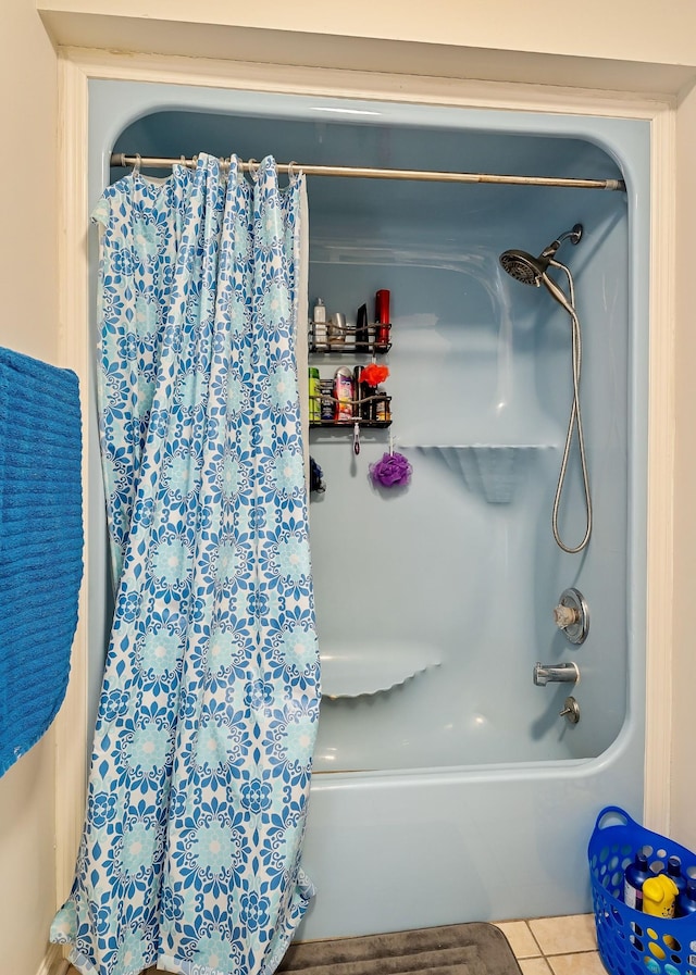 full bath with tile patterned floors and shower / tub combo with curtain