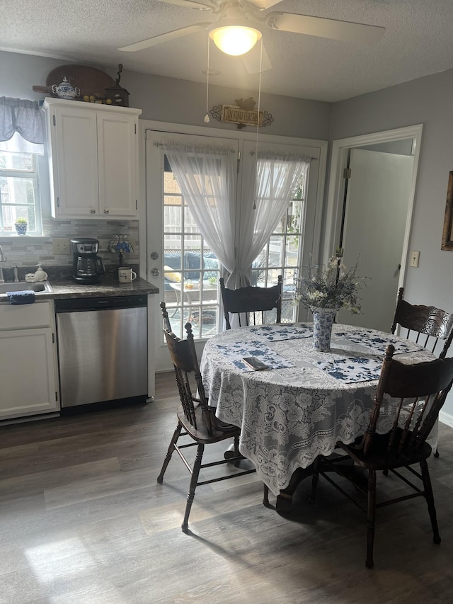 dining space with light wood finished floors, a healthy amount of sunlight, a textured ceiling, and a ceiling fan