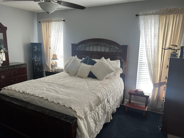 bedroom featuring multiple windows and ceiling fan