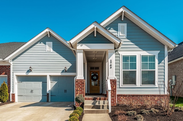 view of front of property featuring brick siding, a garage, and driveway