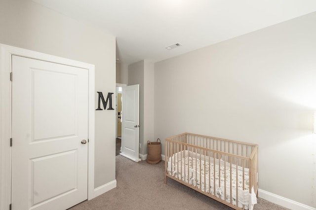 bedroom with visible vents, baseboards, and carpet