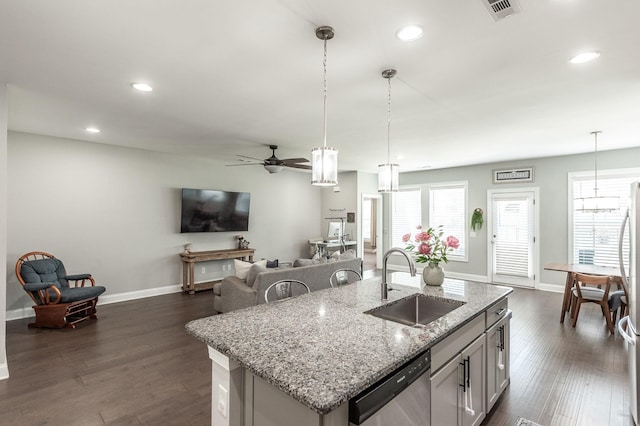 kitchen featuring dark wood-style floors, visible vents, dishwasher, and a sink