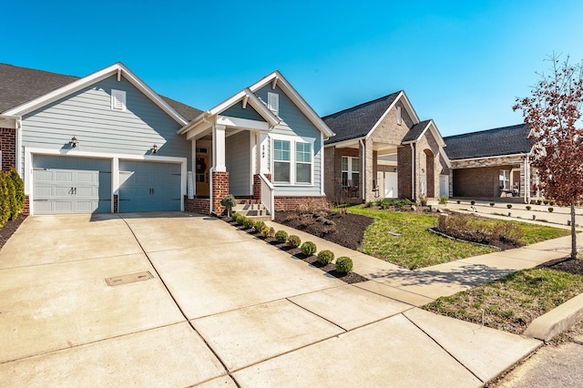 view of front facade with concrete driveway, a garage, and brick siding