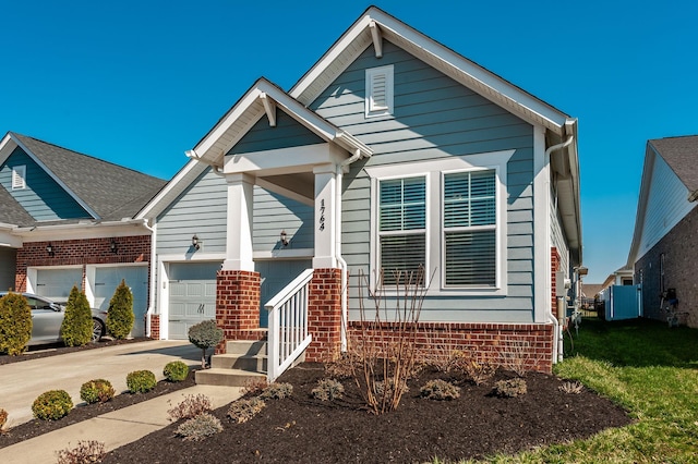 view of front of property with a garage, brick siding, and concrete driveway