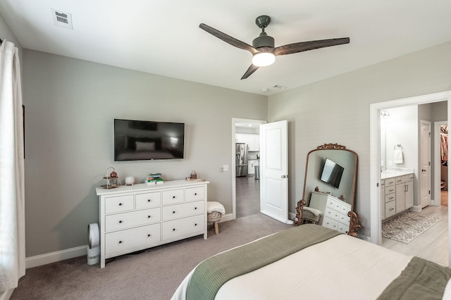 bedroom featuring light carpet, visible vents, stainless steel refrigerator with ice dispenser, and baseboards