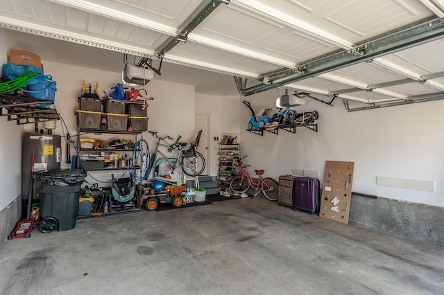 garage featuring electric water heater and a garage door opener