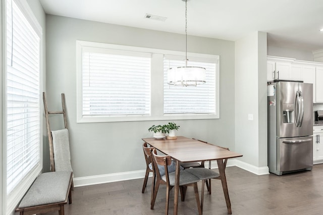 dining space featuring a healthy amount of sunlight, visible vents, dark wood-style flooring, and baseboards