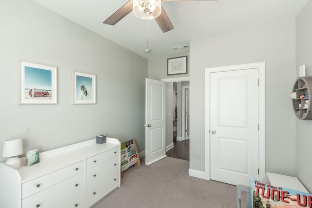 bedroom featuring visible vents, light colored carpet, baseboards, and ceiling fan