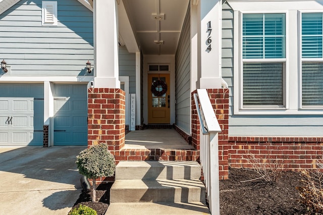 entrance to property featuring brick siding and concrete driveway