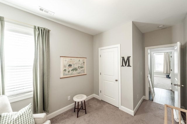 bedroom featuring light colored carpet, visible vents, and baseboards