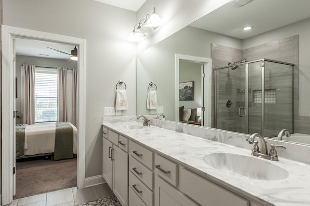 full bath with a sink, a shower stall, ensuite bathroom, and double vanity