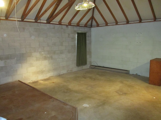 interior space with concrete block wall and a baseboard heating unit