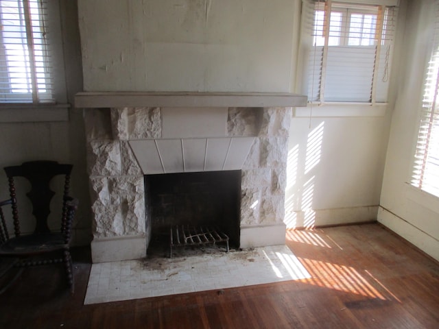 interior details with baseboards, wood finished floors, and a fireplace