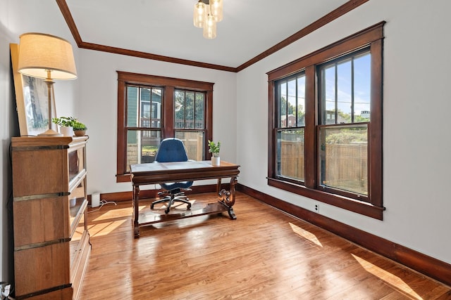 home office with light wood-style flooring, crown molding, and baseboards