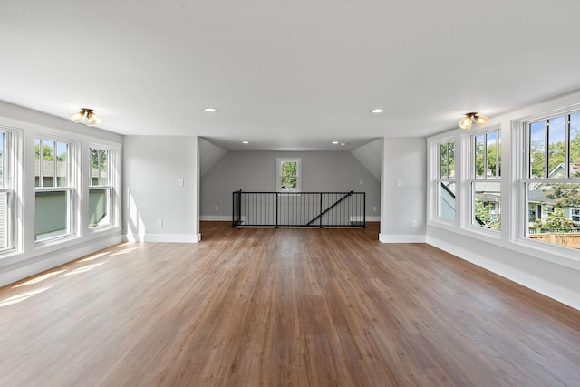 unfurnished living room featuring recessed lighting, baseboards, and wood finished floors